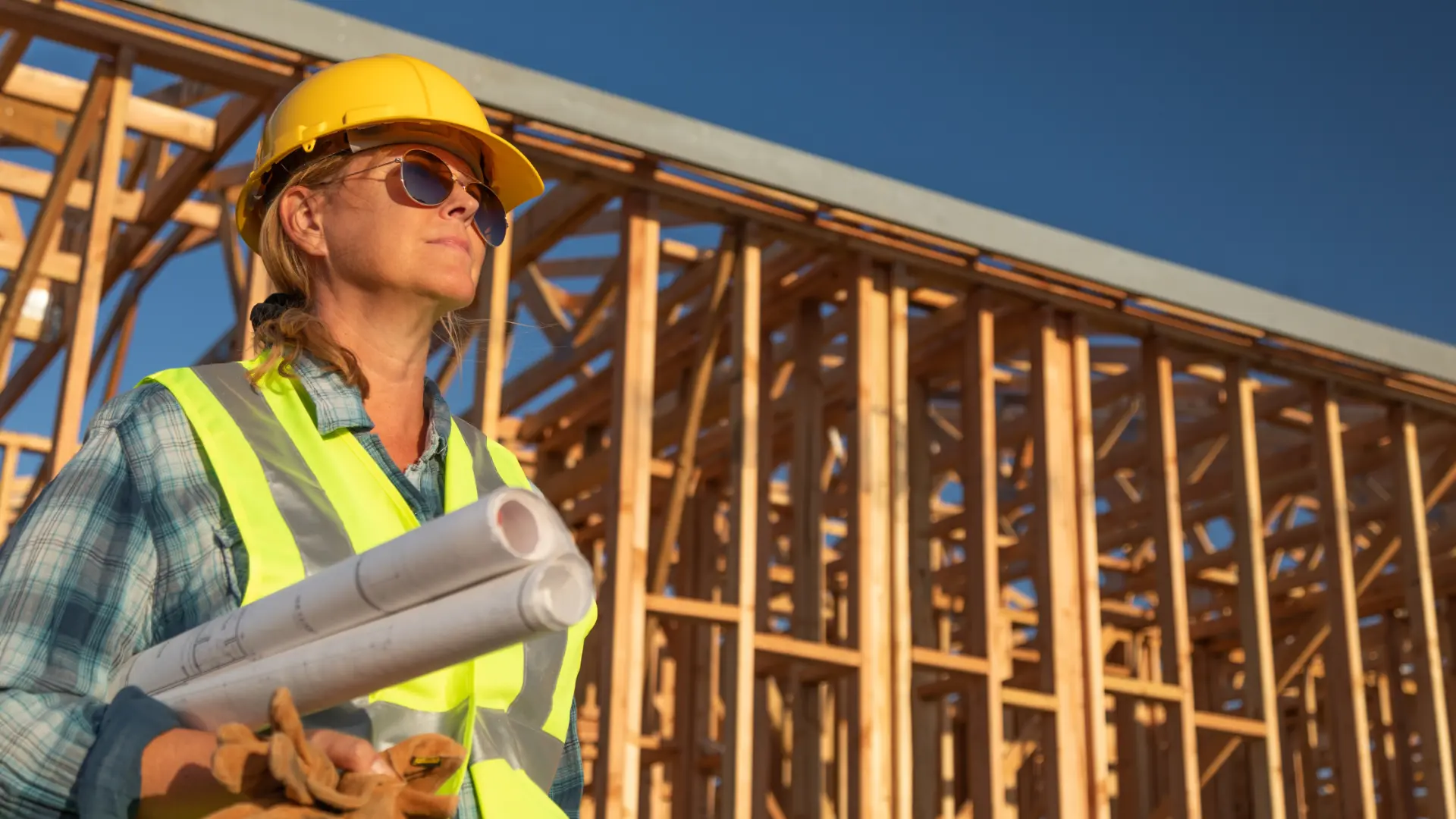 Construction professional reviewing plans on a job site